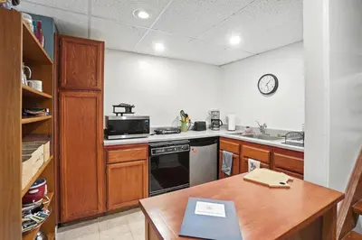 a kitchen with a stove and a sink and a table at 10 Mi to Dtwn Cozy Couples Getaway in Cincinnati in Cincinnati