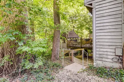 a house with a deck with a tree at 10 Mi to Dtwn Cozy Couples Getaway in Cincinnati in Cincinnati