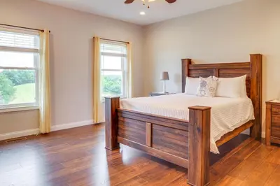 a bedroom with a large bed and two windows at 14 Mi to Ark Encounter Rural Corinth Escape! in Corinth