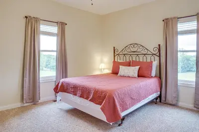 a bedroom with a bed and two windows at 14 Mi to Ark Encounter Rural Corinth Escape! in Corinth