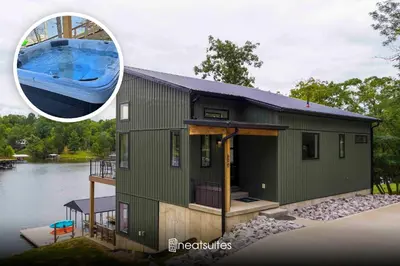 a small green house with a boat on top of it at Lakefront Home with Dock - Hot tub - 7 miles to Ark in Williamstown
