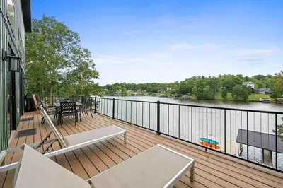 a balcony with a view of a river at Lakefront Home with Dock - Hot tub - 7 miles to Ark in Williamstown