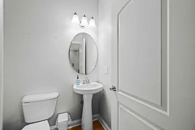 a white bathroom with a sink and a mirror at Hilltop 3BR for 10, Private Garage, Skyline Views in Covington