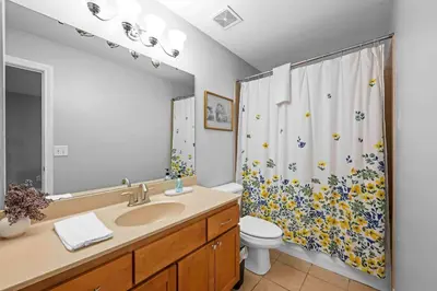 a bathroom with a sink and a toilet and a shower curtain at Hilltop 3BR for 10, Private Garage, Skyline Views in Covington