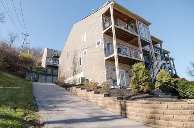 a large building with a balcony on the side of it at Hilltop 3BR for 10, Private Garage, Skyline Views in Covington