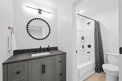 a bathroom with a sink and a toilet and a mirror at Hot Tub, 3BR for 10, Near Ark, Private Parking in Dry Ridge
