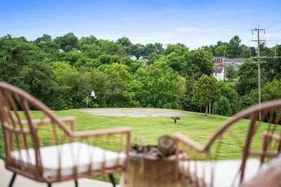 a view of a park with two chairs and a basketball court at Hot Tub, 3BR for 10, Near Ark, Private Parking in Dry Ridge