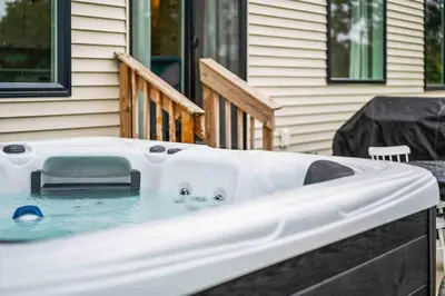 a hot tub in front of a house at 4BR, 2 & half Bath, Hot Tub, Private Parking, Near Ark in Dry Ridge