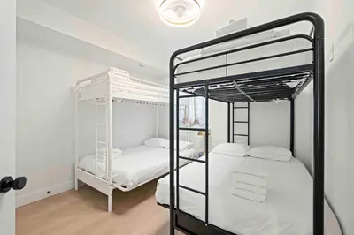 two bunk beds in a room with white walls at 4BR, 2 & half Bath, Hot Tub, Private Parking, Near Ark in Dry Ridge