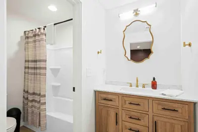 a bathroom with a sink and a mirror at 4BR, 2 & half Bath, Hot Tub, Private Parking, Near Ark in Dry Ridge
