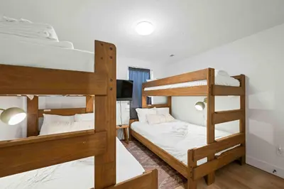 a bedroom with two bunk beds and a television at 3-story home for 12 Near Ark with Hot Tub & Parking! in Dry Ridge