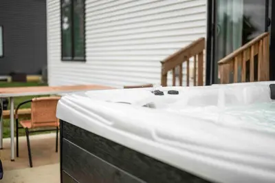 a bath tub sitting on top of a porch at 3-story home for 12 Near Ark with Hot Tub & Parking! in Dry Ridge