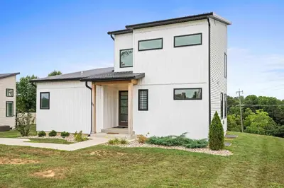 a white house with a black roof at 3-story home for 12 Near Ark with Hot Tub & Parking! in Dry Ridge