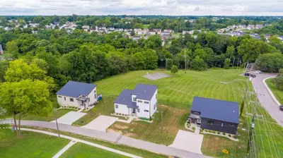 an aerial view of a house with a yard at 3 Homes, 3 Hot Tubs, 10BR, 10 Bath, Near Ark! in Dry Ridge