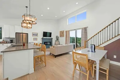 a kitchen and living room with a table and chairs at 3 Homes, 3 Hot Tubs, 10BR, 10 Bath, Near Ark! in Dry Ridge