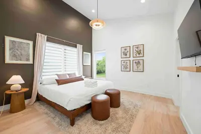 a bedroom with a large bed and a window at 3 Homes, 3 Hot Tubs, 10BR, 10 Bath, Near Ark! in Dry Ridge