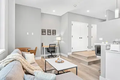 a living room with a couch and a table at Modern DT Stay, King Bed, Parking Available in Cleveland