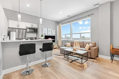 a living room with a couch and a table at Modern DT Stay, King Bed, Parking Available in Cleveland