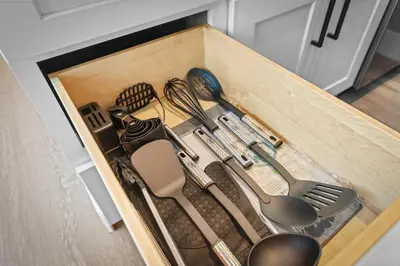 a wooden box filled with utensils in a drawer at Modern DT Stay, King Bed, Parking Available in Cleveland