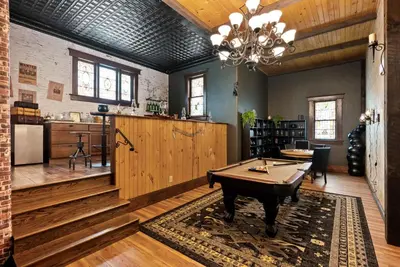 a room with a ping pong table and a kitchen at School of Sorcery in Brinkhaven