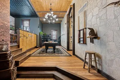 a hallway with a piano in the middle of a room at School of Sorcery in Brinkhaven