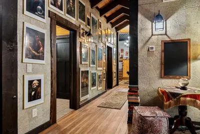 a hallway with paintings on the walls at School of Sorcery in Brinkhaven