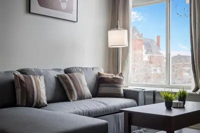 a living room with a couch and a large window at Cozy 2BR Getaway, King Bed, Free Parking in Cleveland