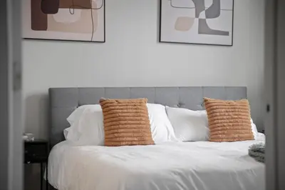 a bed with two pillows on top of it at Cozy 2BR Getaway, King Bed, Free Parking in Cleveland