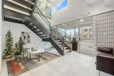 a living room with a staircase and a table at Cozy 2BR Getaway, King Bed, Free Parking in Cleveland