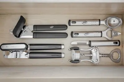 a group of different tools in a wooden drawer at 1BR Retreat, 2 Smart TVs, WiFi & Free Parking in Cleveland