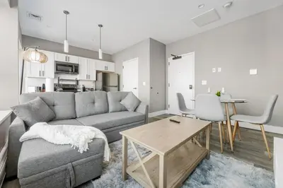 a living room with a couch and a table at 1BR Retreat, 2 Smart TVs, WiFi & Free Parking in Cleveland