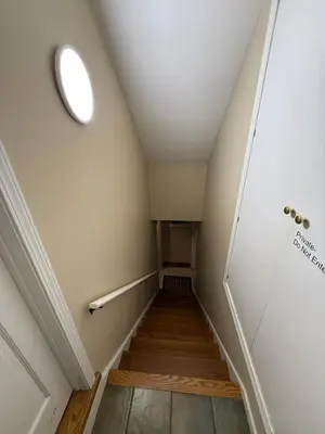 a hallway with a stairwell with a round ceiling at Old Orchard