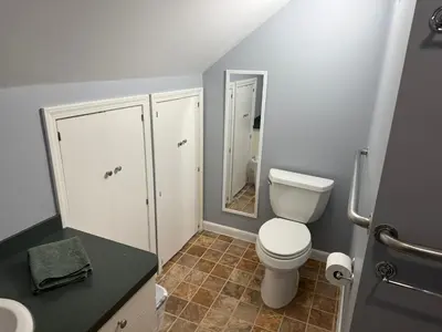 a small bathroom with a toilet and a mirror at Old Orchard