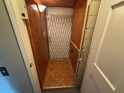 a shower with a wooden door in a room at Old Orchard