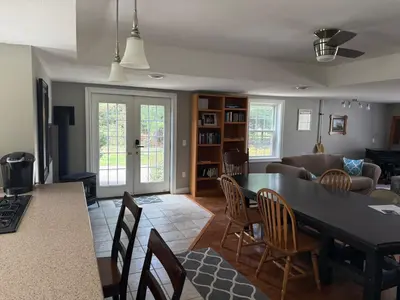 a kitchen and living room with a table and chairs at Old Orchard