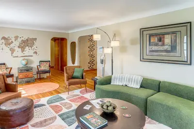 a living room with a green couch and a table at Less Than 1 Mi to Dtwn Tiffin Home with Outdoor Space! in Tiffin