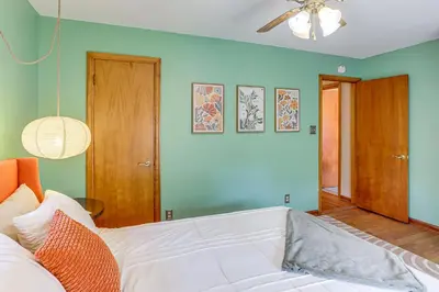 a white bed in a room with blue walls at Less Than 1 Mi to Dtwn Tiffin Home with Outdoor Space! in Tiffin