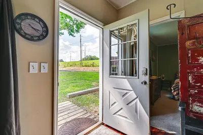 an open door with a clock on the wall at 4 Mi to Ohio River Quiet Guest House with Yard!
