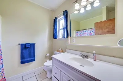 a bathroom with a sink and a toilet and a mirror at 4 Mi to Ohio River Quiet Guest House with Yard!