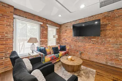 a living room with a brick wall at Short North Lounge - Stay for 2 in Columbus