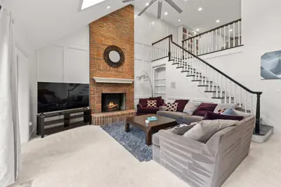 a living room with a couch and a fireplace at The Gahanna Grand in Columbus