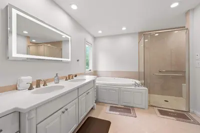 a bathroom with a tub and a sink and a shower at The Gahanna Grand in Columbus