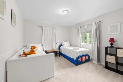 a small bedroom with a bed and a couch at The Gahanna Grand in Columbus