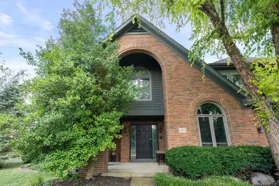 a brick house with a black door and a tree at The Gahanna Grand in Columbus
