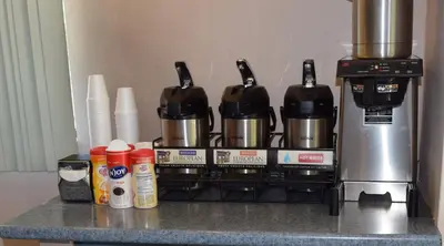 a coffee maker on a counter next to a mixer at Red Roof Inn Parkersburg in Parkersburg