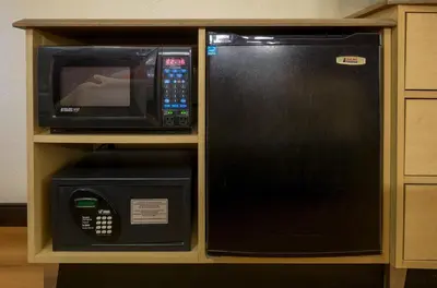 a microwave and a microwave oven in a cabinet at Red Roof Inn Parkersburg in Parkersburg