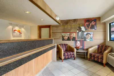 a waiting room with two chairs and a counter at Red Roof Inn Parkersburg in Parkersburg