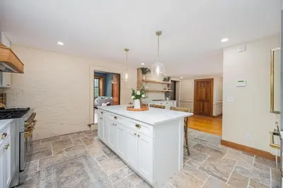 a kitchen with white cabinets and a kitchen island at Bellawood Farmhouse in Canal Winchester