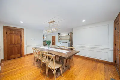 a dining room with a large wooden table and chairs at Bellawood Farmhouse in Canal Winchester