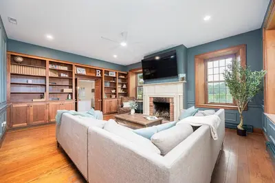 a living room with a white couch and a fireplace at Bellawood Farmhouse in Canal Winchester